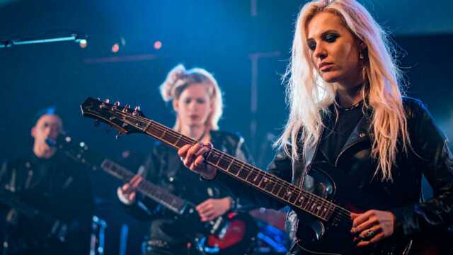 image female metal band performing on stage